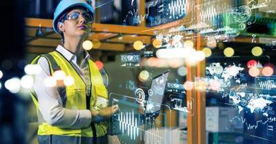 Woman in hard hat working in manufacturing company