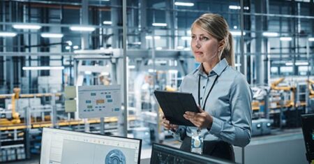 woman with clip board in manufacturing business