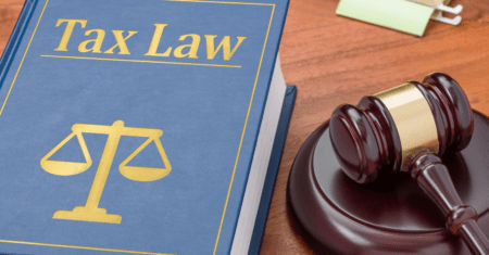 book with scale of justice symbol and tax law on cover