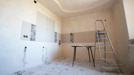 ladder in the middle of a room that is under renovation