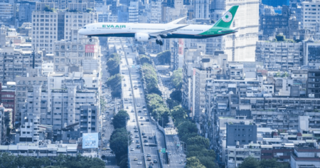 airplane flying over large city